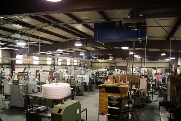 Blue Ox Air Cleaners hanging in Spring Creek Machining to provide black process dust removal.