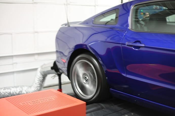 Vehicle being dyno tested and vehicle exhaust removal in process.