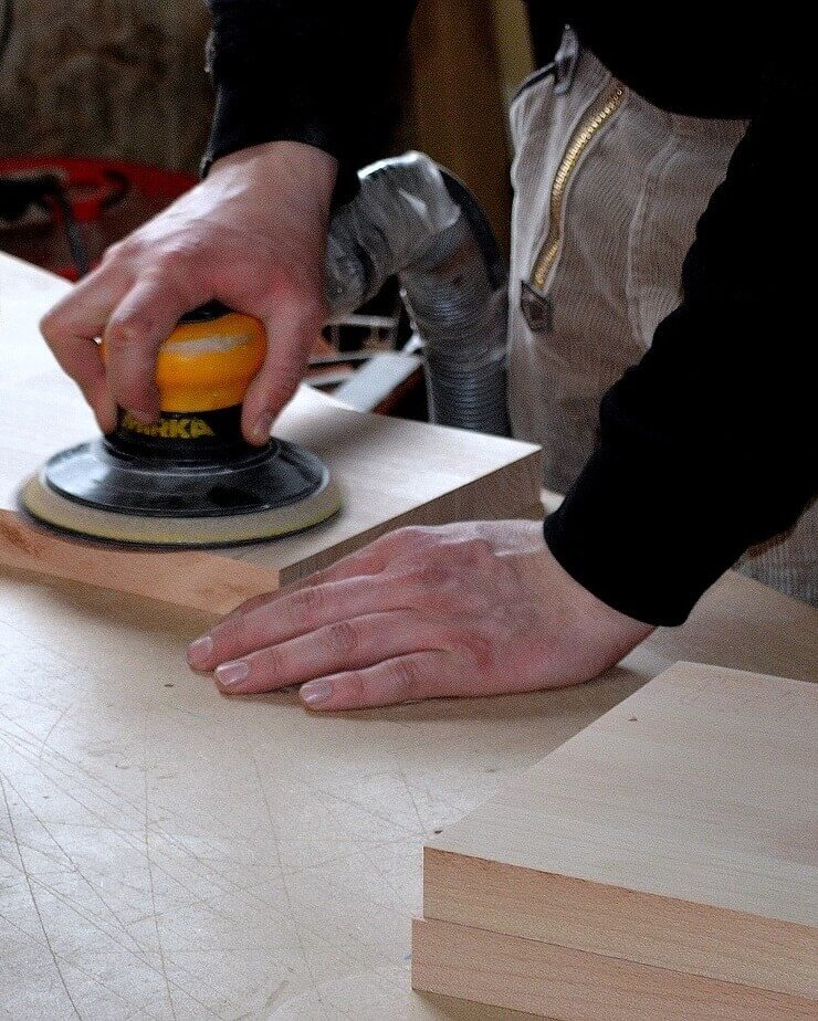 Wood being sanded and finished.