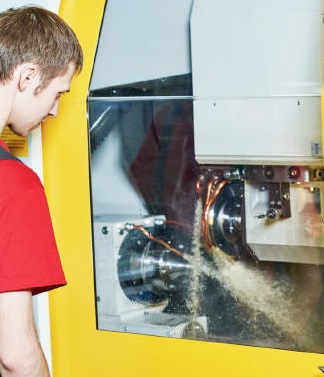 A machine operator working with industrial equipment.